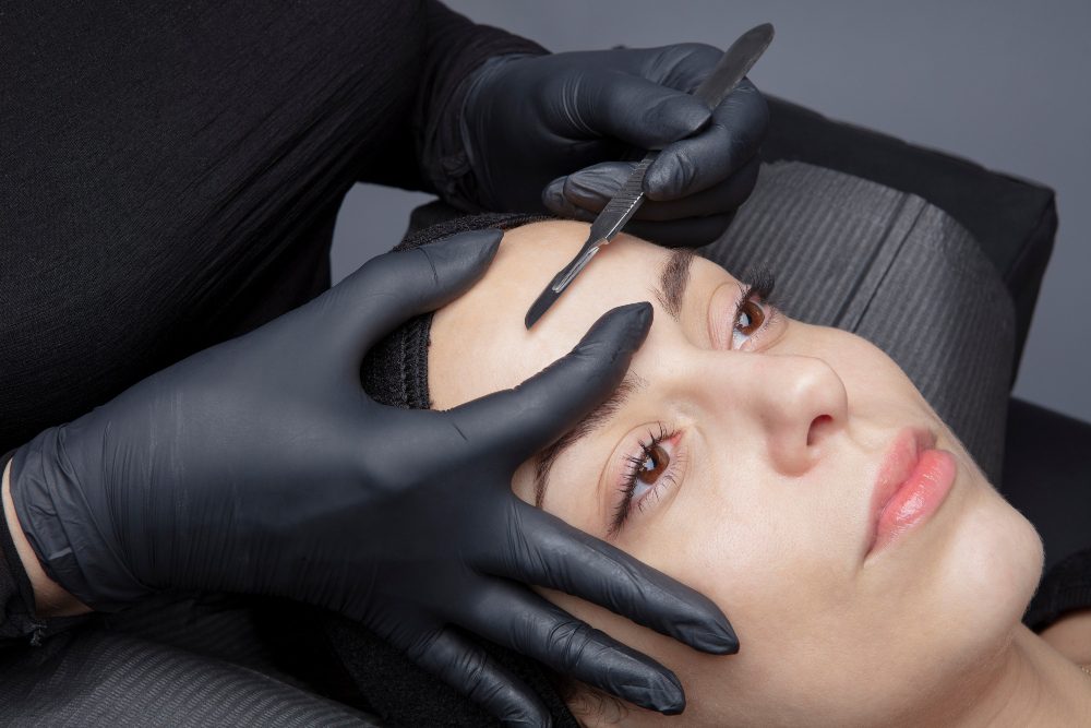 A Person Putting Eyelash Extension on the Client 