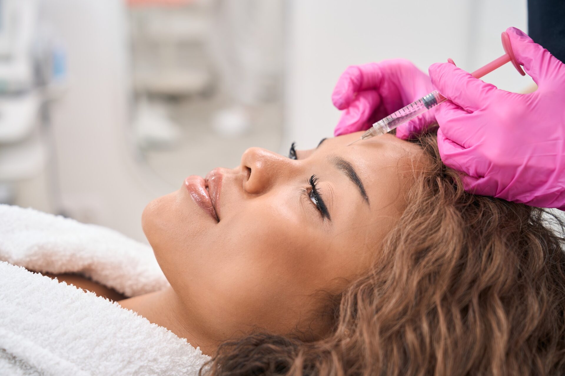 Woman receiving facial aesthetics injection