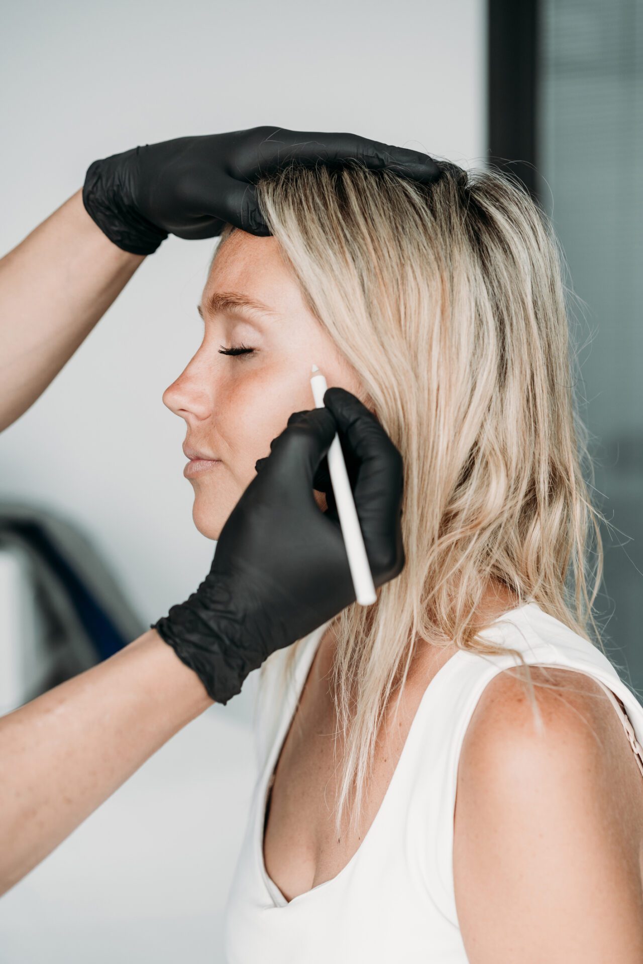 A Person Putting Eyelash Extension on the Client 